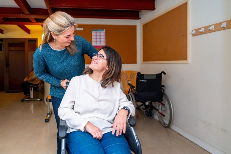 Disabled woman in wheelchair with NDIS Provider caregiver