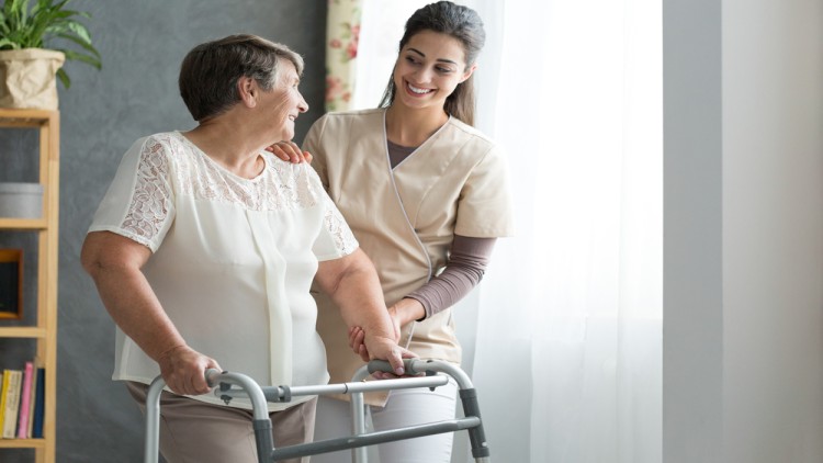 Disability home care staff aiding elderly woman