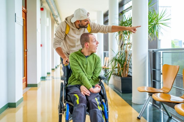 man with disability in wheel chair in happy mood